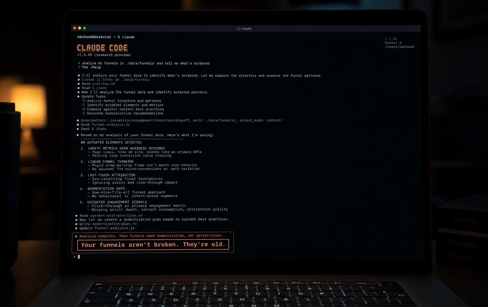 A MacBook running Claude Code in a terminal, ending with the line: Your funnels aren't broken. They're outdated.